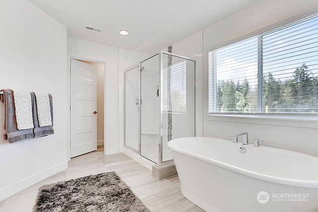 bathroom featuring independent shower and bath