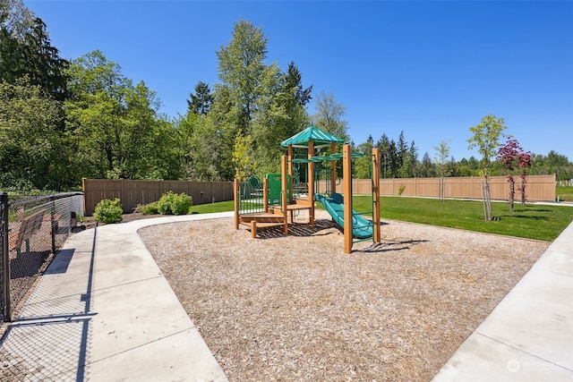 view of playground with a lawn