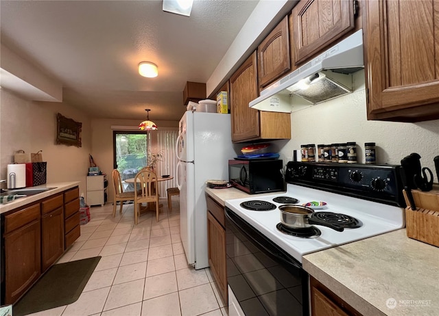 712714 142nd Pl SE, Bellevue, WA 98007 - kitchen featuring range with electric cooktop, under cabinet range hood, black microwave, light countertops, and light tile patterned floors