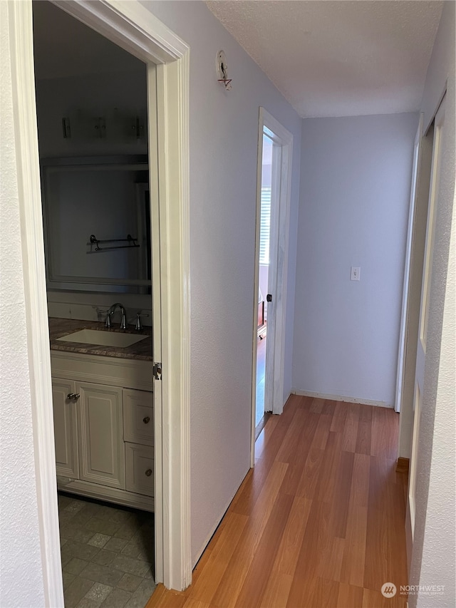 hall featuring sink and hardwood / wood-style flooring