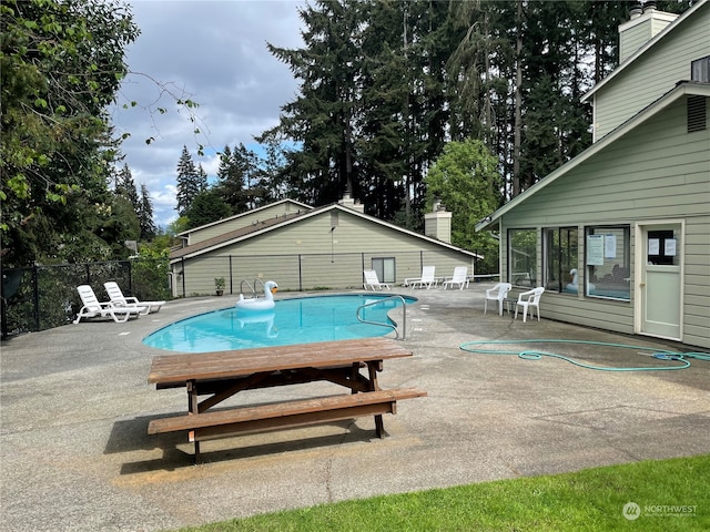 view of swimming pool with a patio area