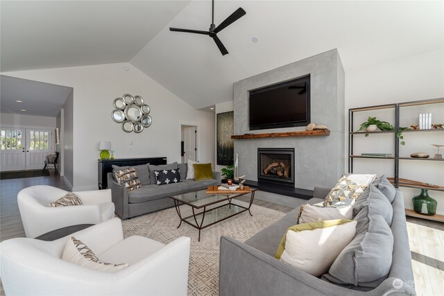 living room with a premium fireplace, wood-type flooring, ceiling fan, and vaulted ceiling