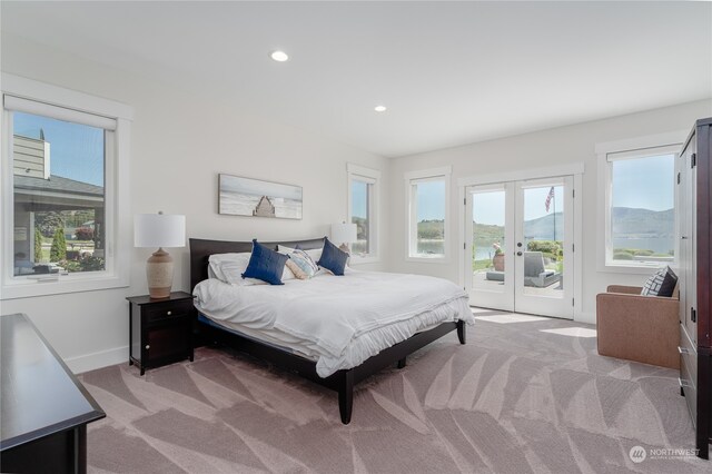 carpeted bedroom with french doors and access to outside