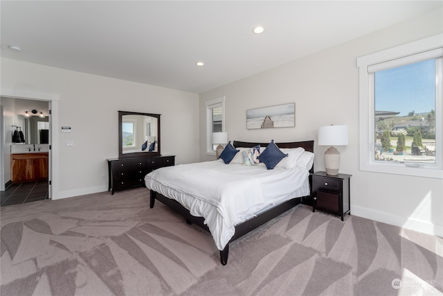 carpeted bedroom featuring ensuite bathroom