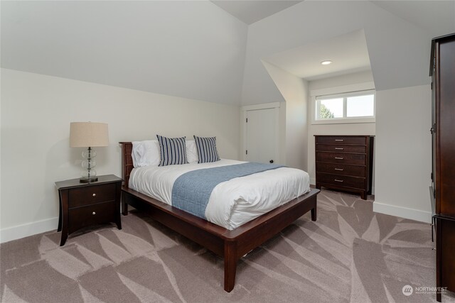 carpeted bedroom featuring lofted ceiling