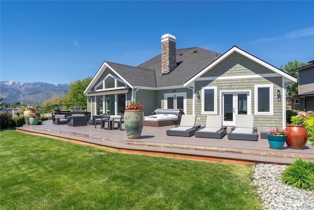 back of property featuring a yard, outdoor lounge area, and a deck with mountain view