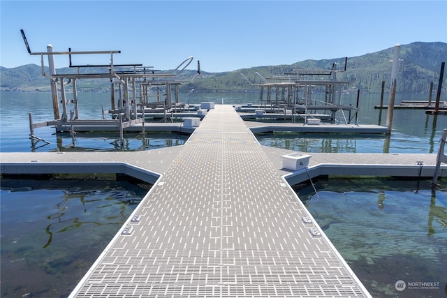 view of dock featuring a water and mountain view