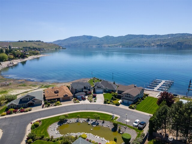 birds eye view of property featuring a water and mountain view