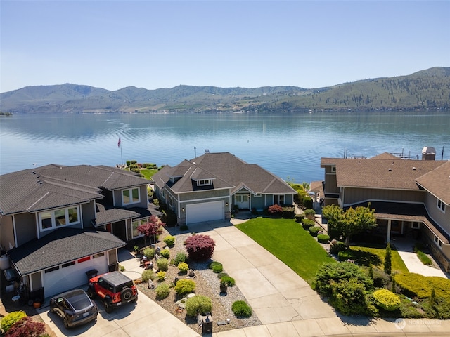 birds eye view of property featuring a water and mountain view