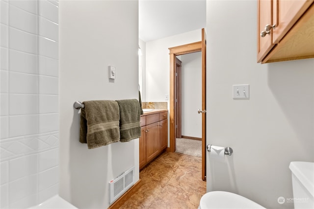 bathroom featuring vanity and toilet