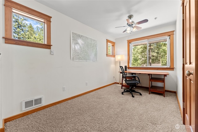 carpeted office featuring ceiling fan