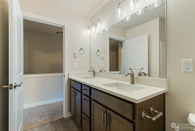 bathroom with hardwood / wood-style floors and double sink vanity