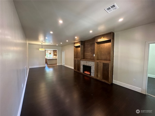 unfurnished living room featuring dark hardwood / wood-style flooring