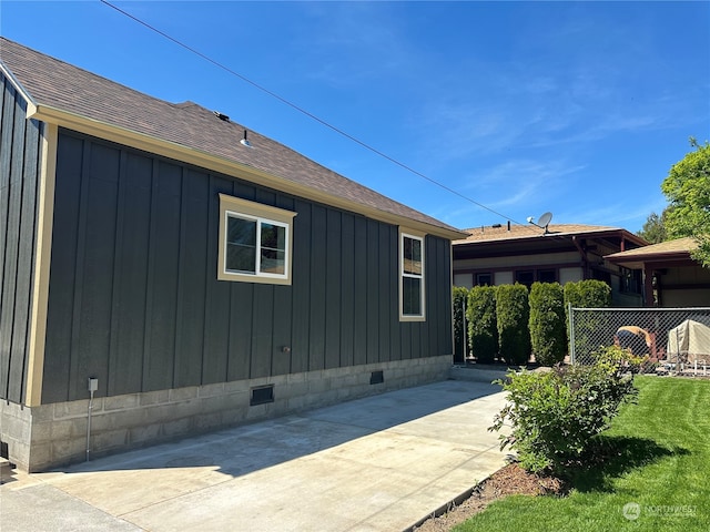 view of property exterior featuring a patio area and a yard