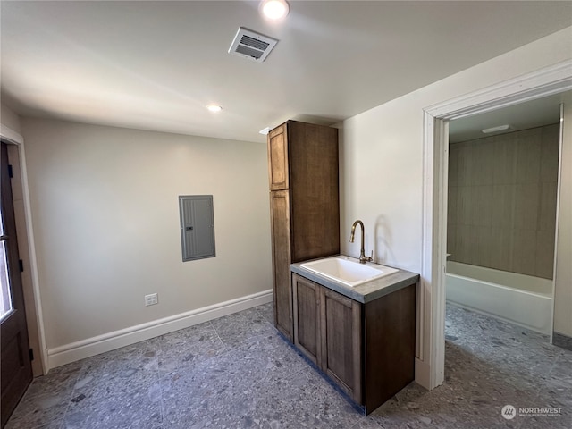 bathroom with vanity, tiled shower / bath, and tile flooring