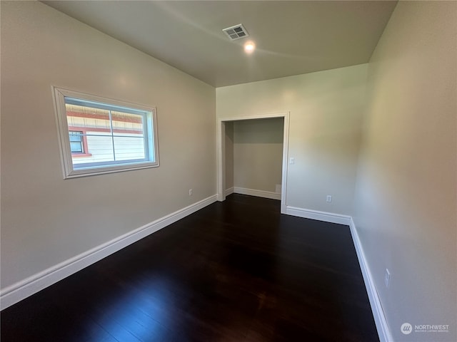 spare room featuring dark hardwood / wood-style flooring