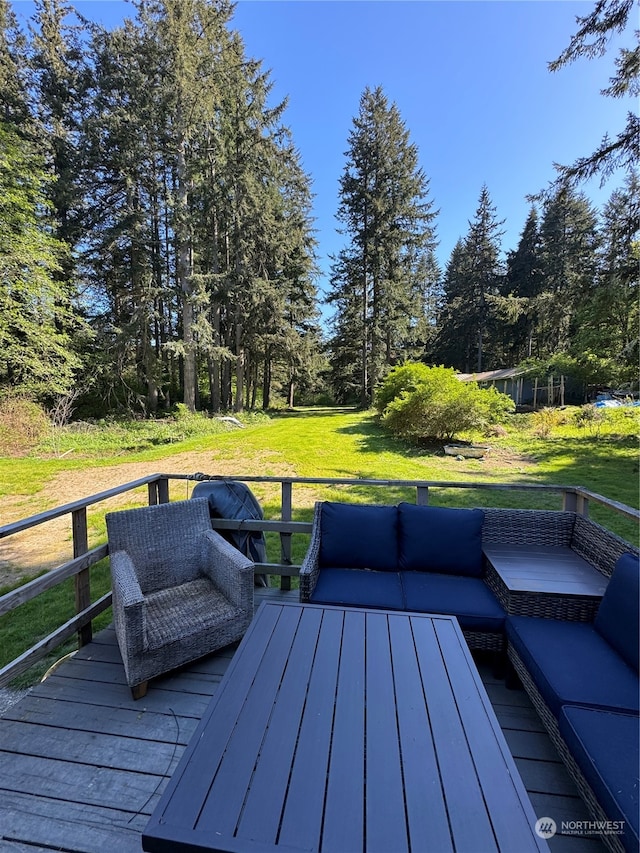 wooden deck featuring a yard and an outdoor hangout area