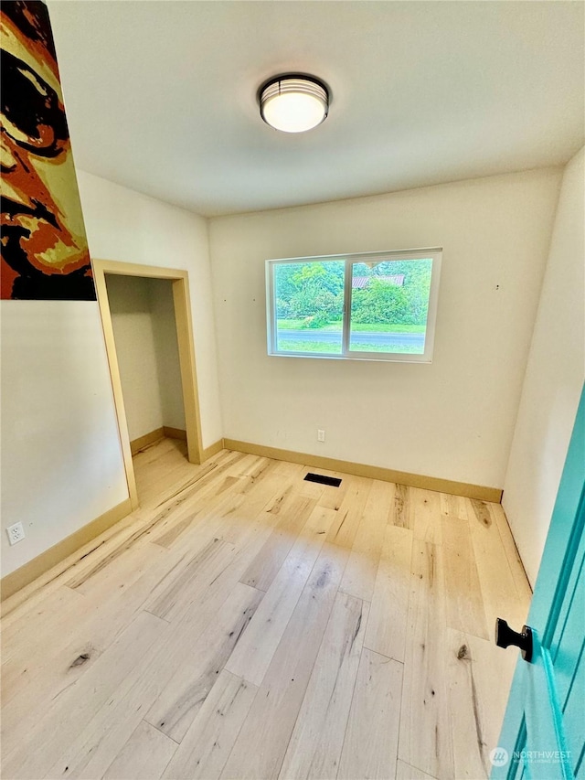 empty room with hardwood / wood-style flooring