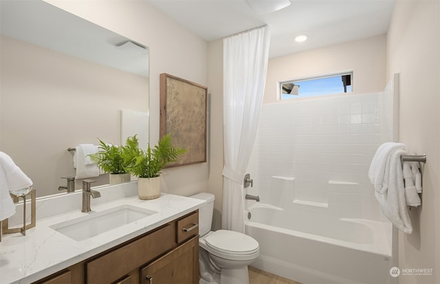 full bathroom with shower / tub combo with curtain, vanity, and toilet