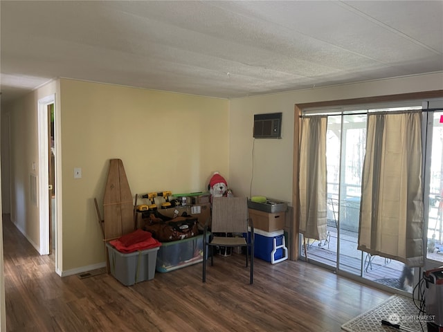 interior space featuring a wealth of natural light, an AC wall unit, and dark hardwood / wood-style flooring