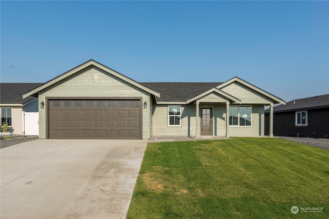 ranch-style house featuring a garage and a front lawn