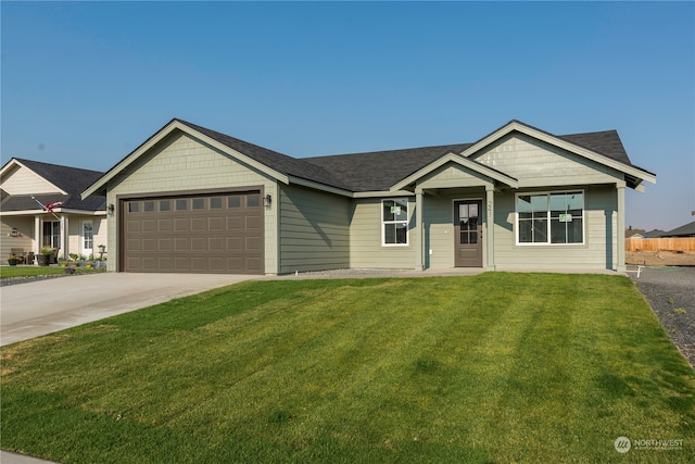 ranch-style home with a front lawn and a garage