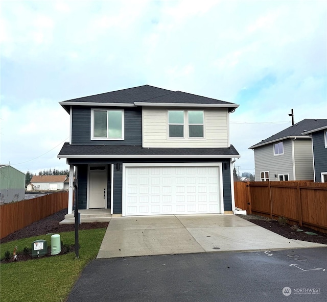 view of front property featuring a front yard and a garage