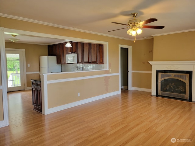 kitchen with dark brown cabinets, ceiling fan, light hardwood / wood-style floors, white appliances, and tasteful backsplash