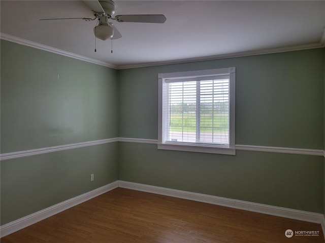 spare room featuring hardwood / wood-style floors, ornamental molding, and ceiling fan