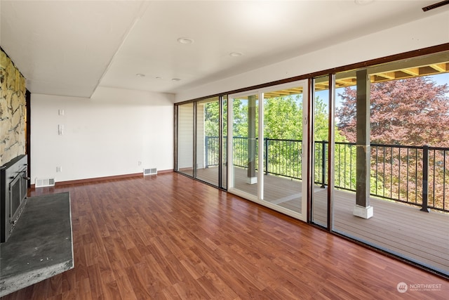 unfurnished living room featuring dark wood-type flooring