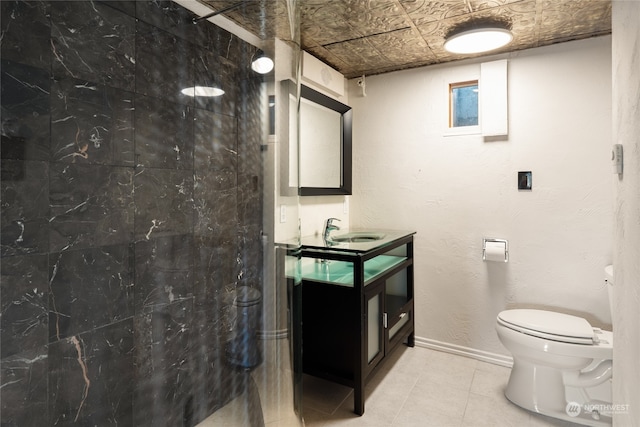 bathroom featuring tile floors, toilet, and vanity