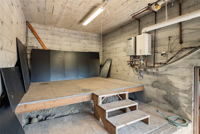 basement featuring a workshop area and tankless water heater