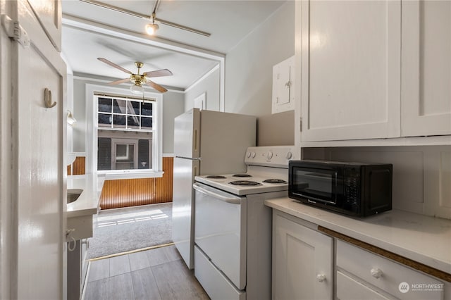 kitchen featuring light hardwood / wood-style floors, ceiling fan, crown molding, white electric range oven, and white cabinets