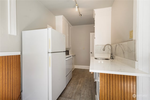 kitchen featuring dark hardwood / wood-style flooring, rail lighting, white cabinetry, sink, and white appliances