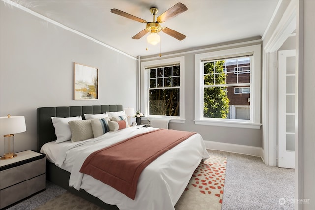 bedroom featuring ornamental molding, carpet floors, and ceiling fan