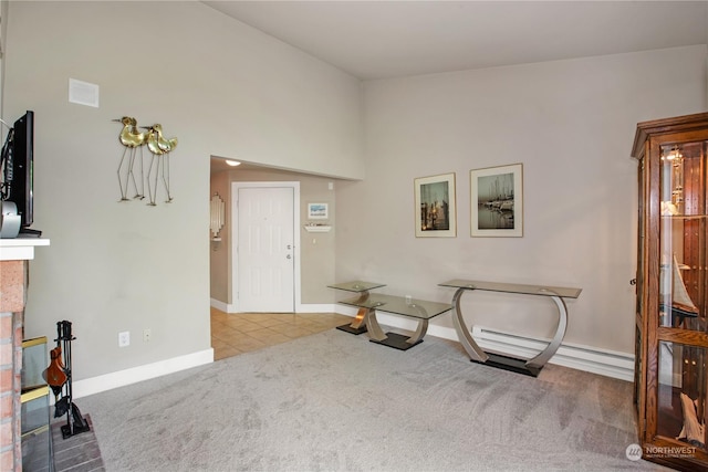 living area with tile patterned floors, visible vents, a baseboard heating unit, carpet, and baseboards