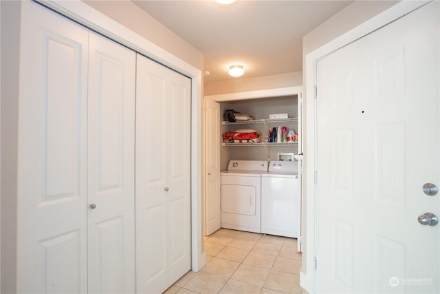 laundry area with light tile patterned floors and independent washer and dryer