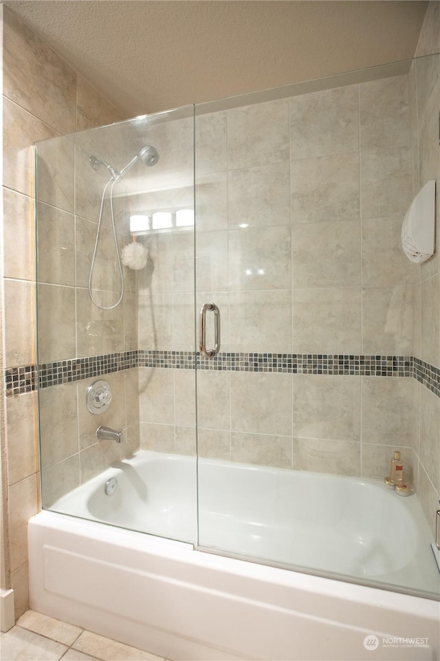 bathroom with tile patterned floors and combined bath / shower with glass door