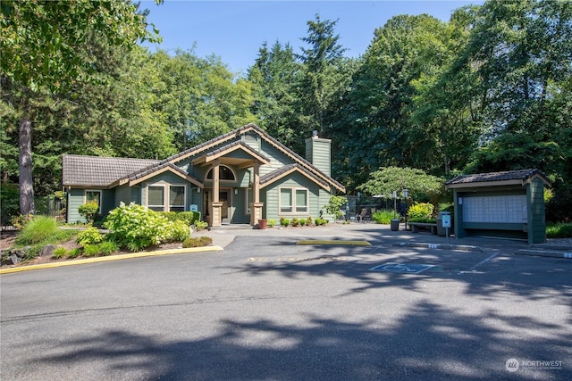 view of front of property featuring a garage and an outdoor structure