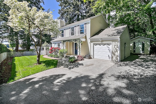 view of front of property with a front lawn and a shed