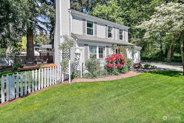 view of property with a front yard and a deck