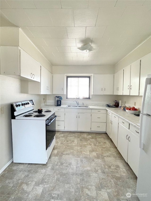 kitchen with sink, white appliances, white cabinetry, and light tile floors