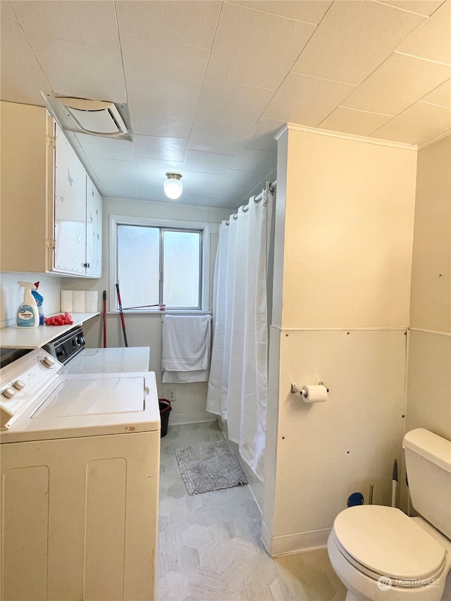 washroom with independent washer and dryer and light tile flooring