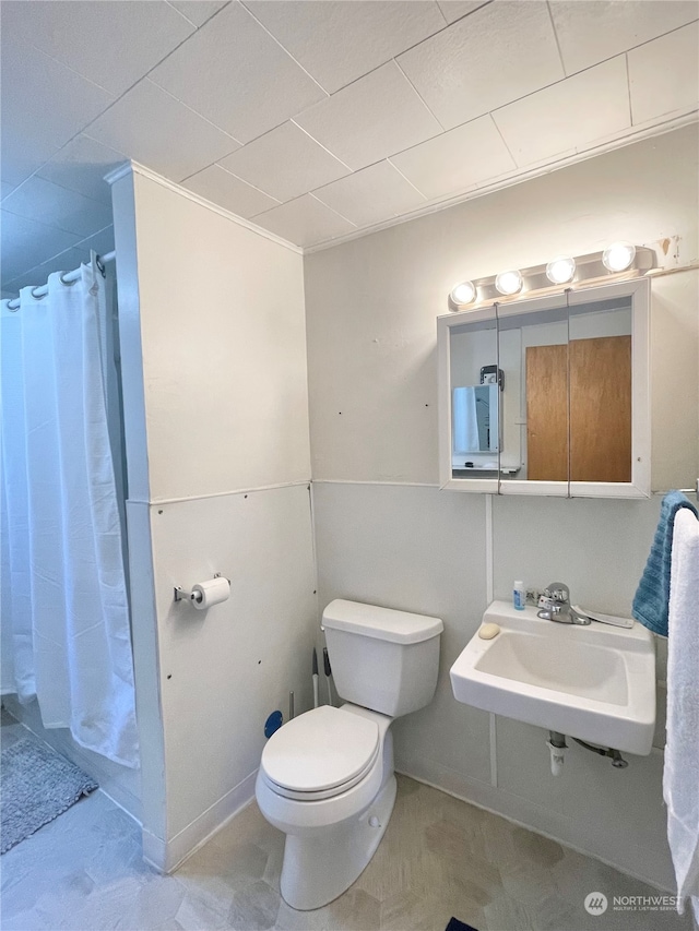 bathroom with tile floors, sink, and toilet