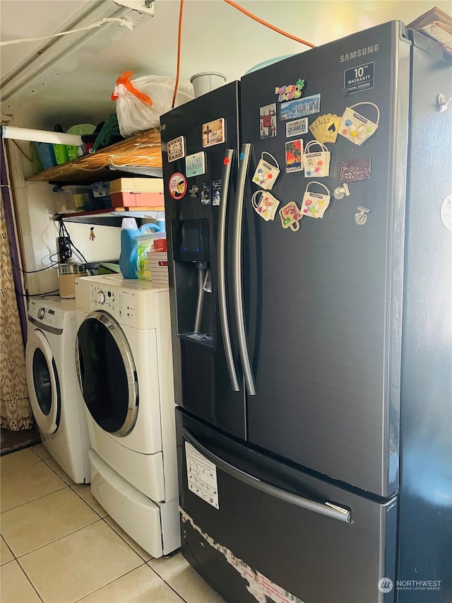 laundry area with light tile patterned floors and independent washer and dryer