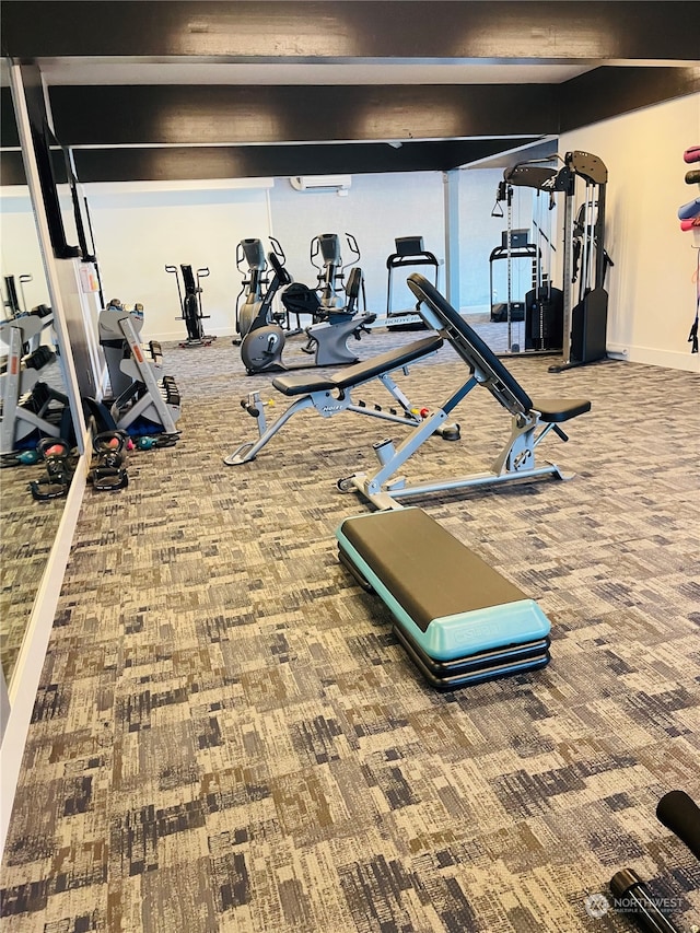 exercise room with carpet flooring and an AC wall unit