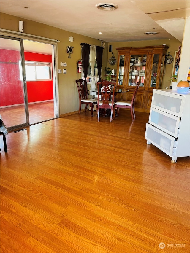 unfurnished dining area with light wood-type flooring