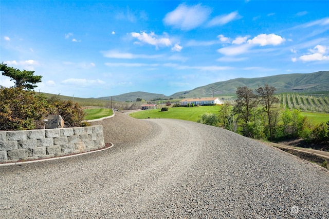 view of road featuring a mountain view and a rural view