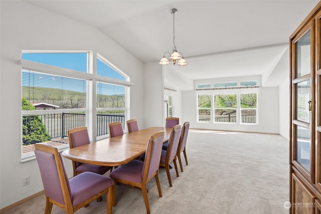 carpeted dining area with vaulted ceiling and a notable chandelier