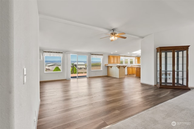 unfurnished living room featuring ceiling fan and carpet